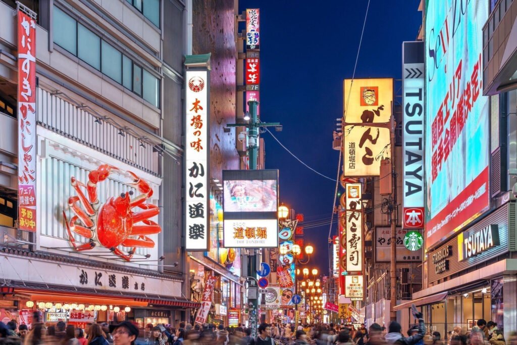 Colorful neon signs illuminating the busy streets of Dotonbori Osaka at night