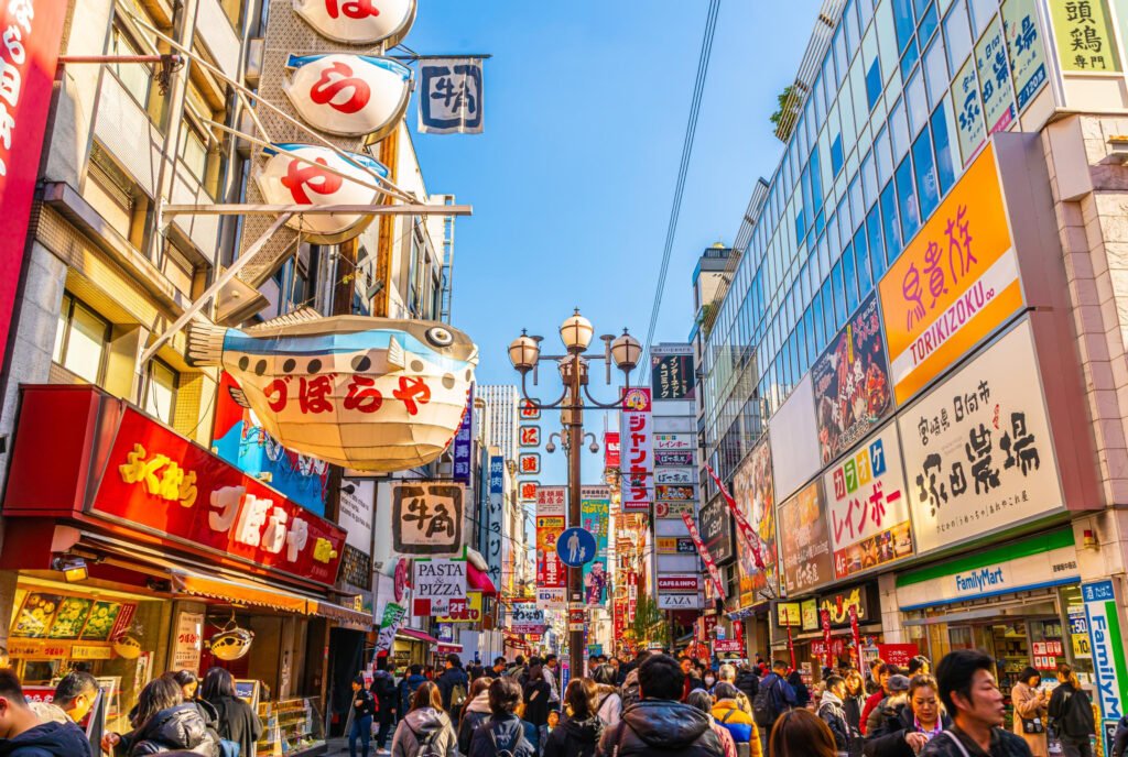 Busy shopping street with colorful signs in the Namba and Shinsaibashi area of Osaka