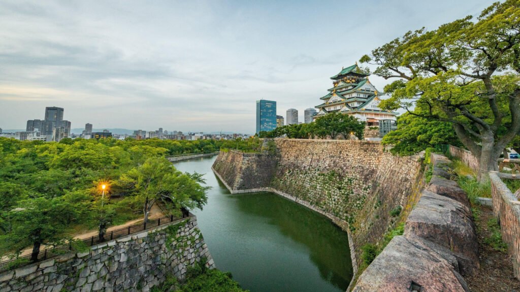 Osaka Castle rising above its historic stone walls and surrounding moat in Japan