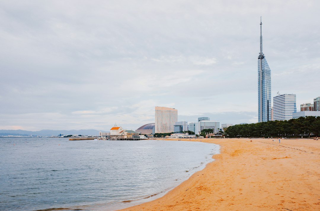 Fukuoka waterfront and city skyline beneath a cloudy sky