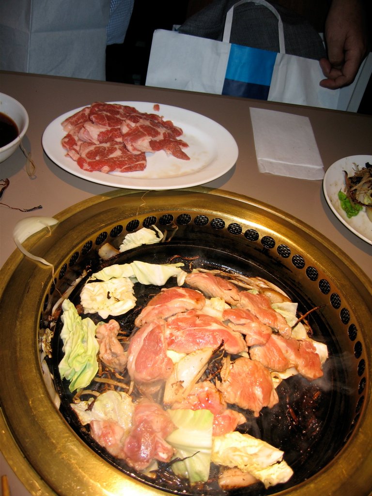 Illustrative jingisukan mutton barbecue on a tabletop grill, not a Sapporo Beer Garden serving.