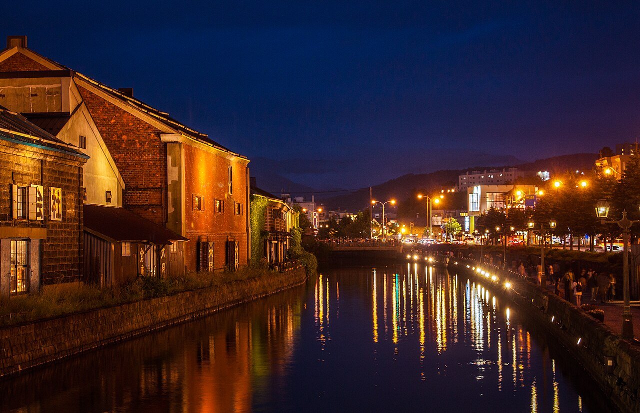Historic Otaru Canal warehouses reflected in the water at dusk, photographed in 2019.