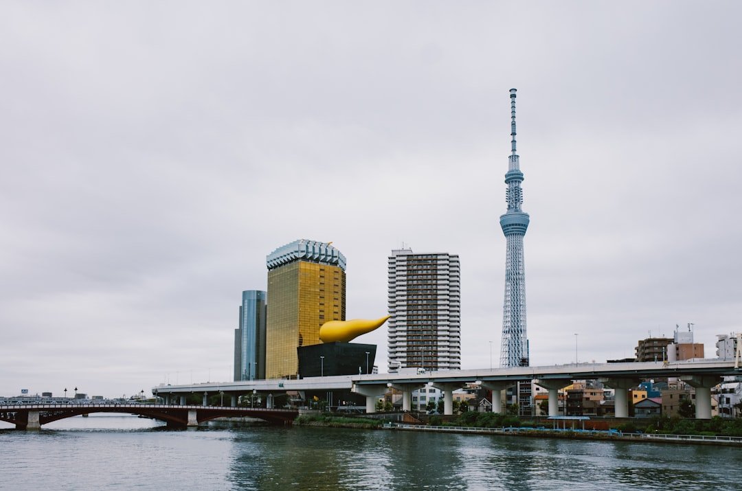 Tokyo Skytree rising beside the Sumida River in daylight