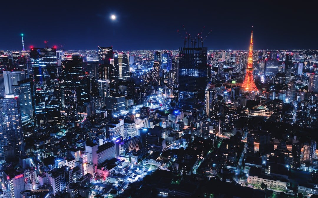 Tokyo Tower glowing among central Tokyo skyscrapers at night