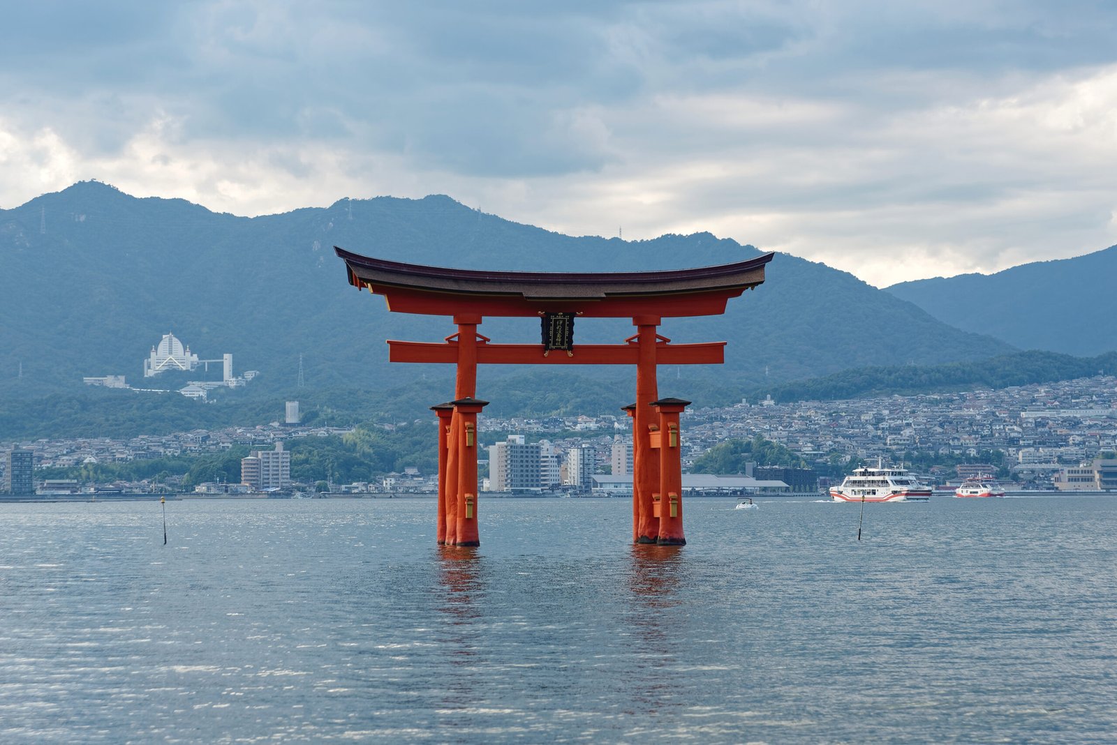 Red Itsukushima torii standing in the sea at Miyajima