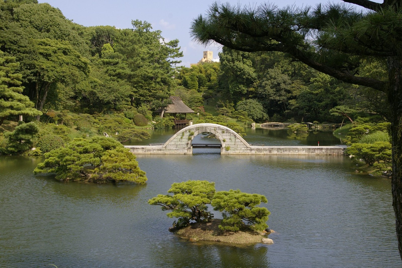 Curved stone Kokokyo Bridge in Shukkeien Garden