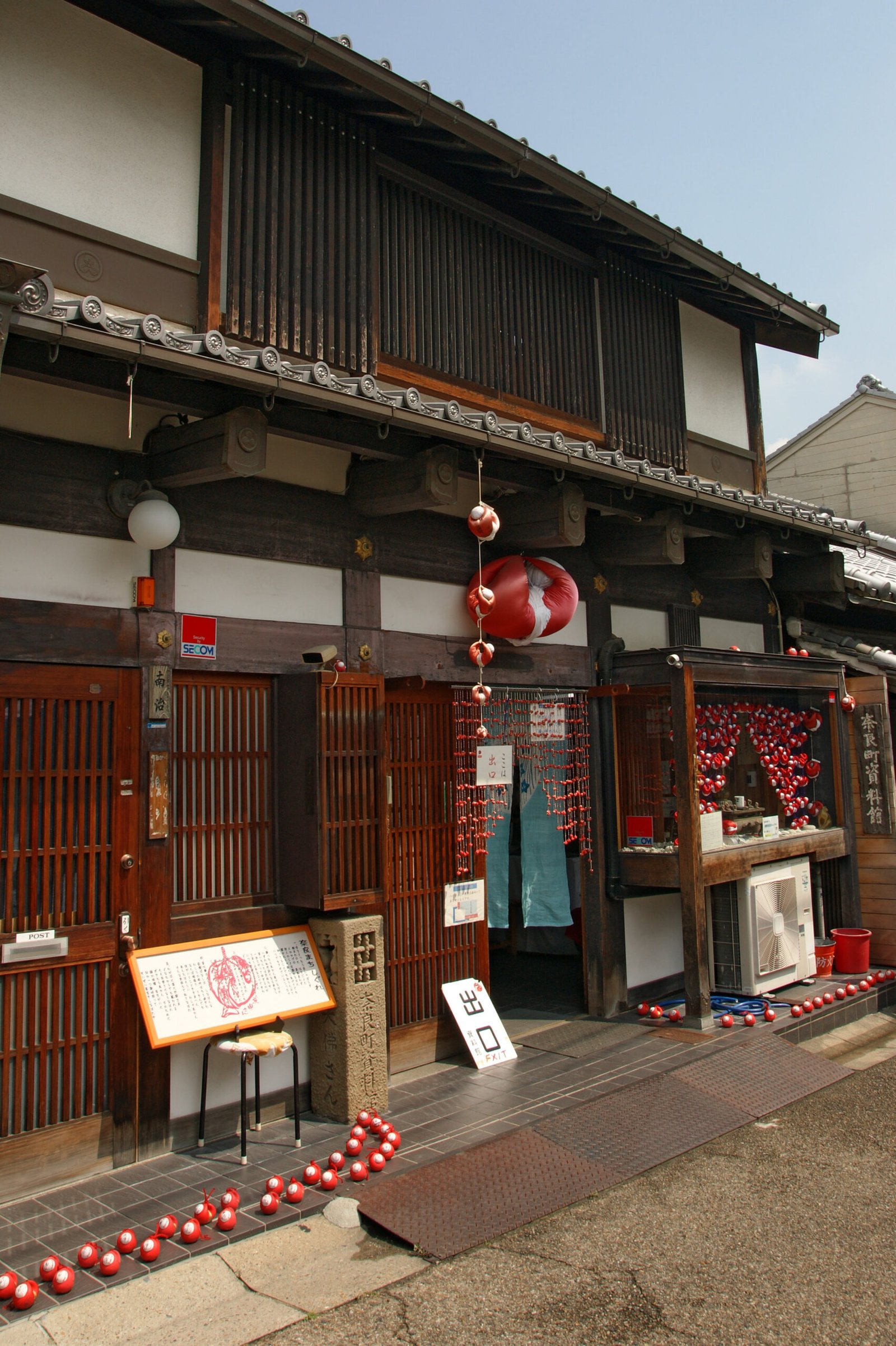 Red migawari-zaru charms outside Naramachi Museum